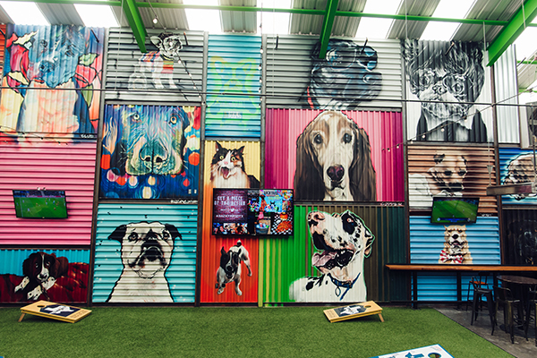 Industrial wall with artistic paintings of dogs