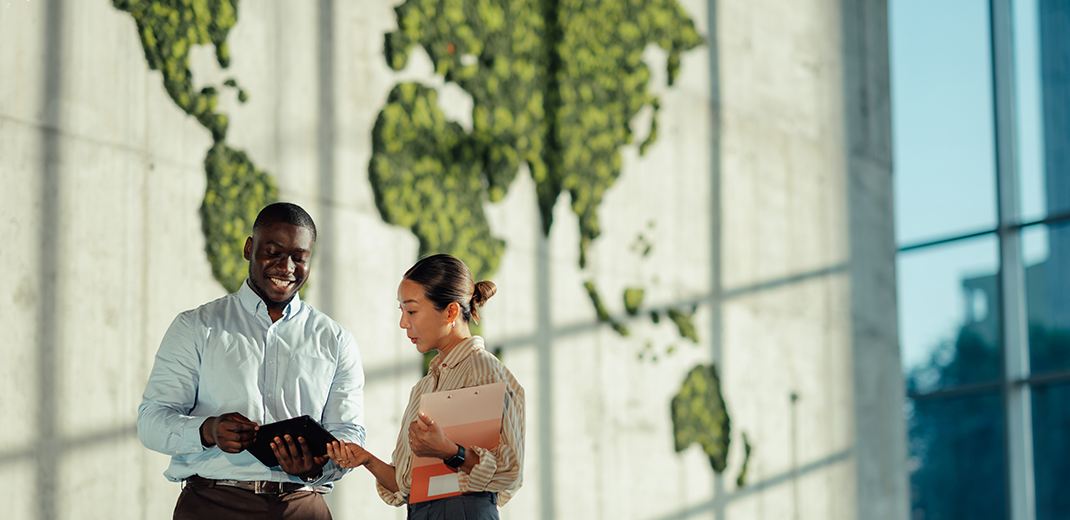 business colleagues discussing sustainability strategy in modern office