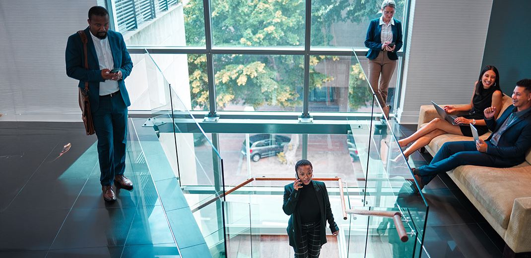 people busy around office stairs