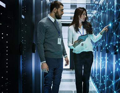 Two people standing and talking in a data center