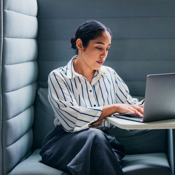 Woman working on a computer in dark room