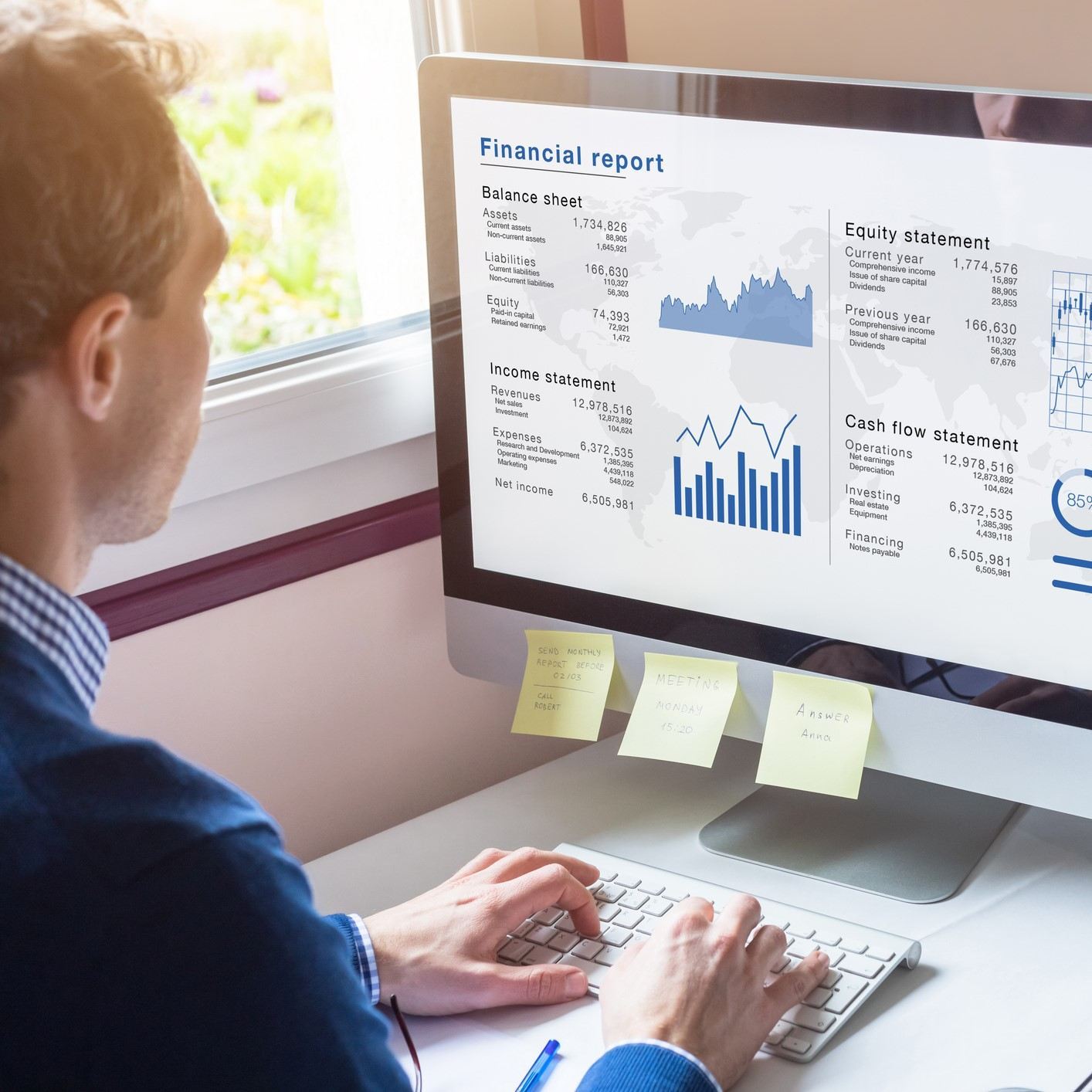 Man working on a financial report on the computer